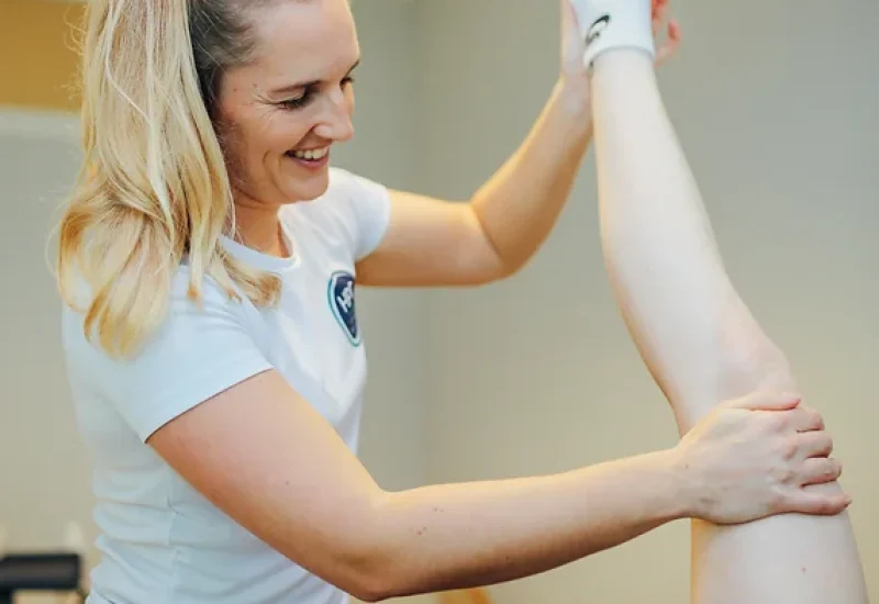 Physiotherapist performing a full-body assessment to identify and address any weaknesses for improved mobility and strength.
