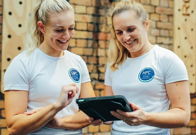 Physiotherapists conducting a lifestyle and training assessment, collaborating with patients to create a personalized plan focused on health and wellness goals.